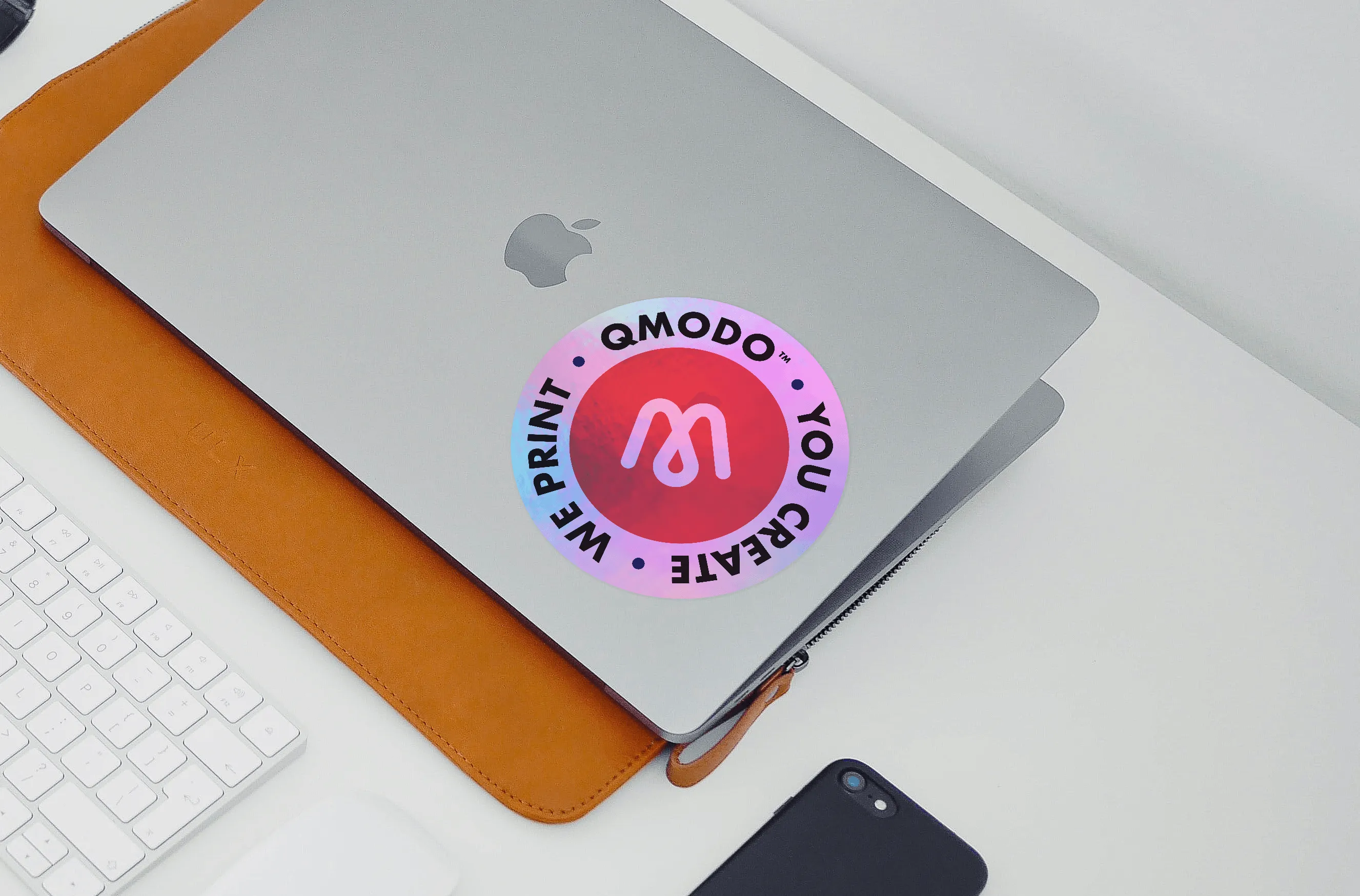 Qmodo — holographic sticker on laptop